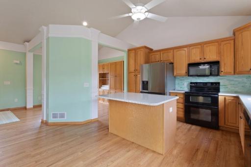 Newer refrigerator, double oven range, and tiled back splash