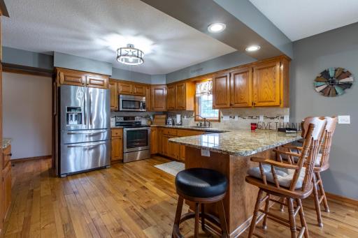 Beautiful kitchen with granite counter tops and breakfast bar