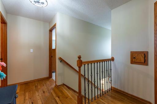 Metal stair spindles and the gorgeous hardwoods continue up through landing in 2nd floor