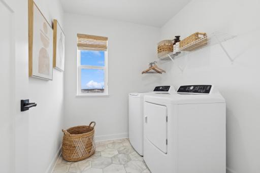 (Photo of a decorated model, actual homes finishes will vary) Upper level laundry.