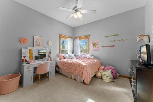 A bright and cheerful bedroom with space for both rest and everyday routines.
