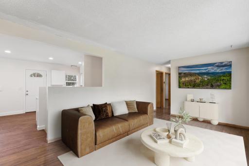 From the moment you step inside, you'll appreciate the abundance of natural light, beautiful hardwood floors, and inviting living spaces designed for comfortable everyday living. The living room virtually staged.
