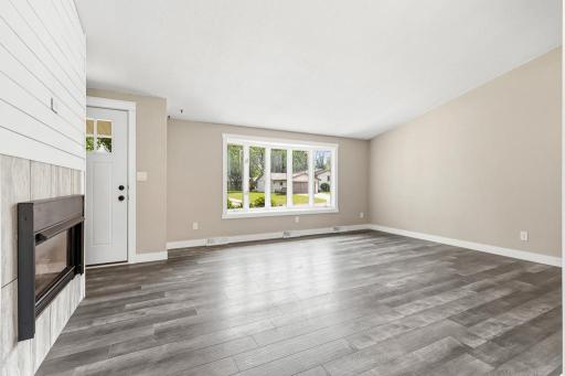 The front door opens up into the living room, dining, and kitchen space! The vaulted ceilings, LVP flooring, fresh paint, new trim, and gas burning fireplace help show it all off!