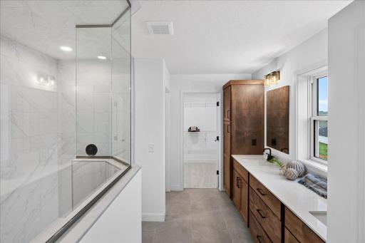 Walk in shower, stool room and walk in closet add to this well-appointed primary suite