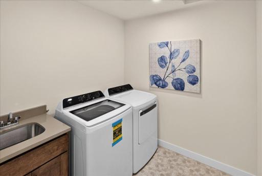 Upper-level washer and dryer with a laundry sink for those pre-soaks or clean up items