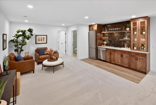 Lower-level wet bar and seating area add to the entertaining value of this home