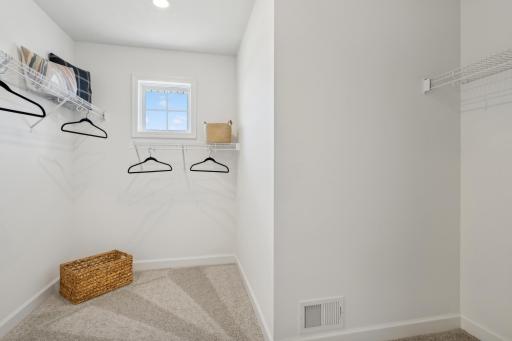 The walk-in closet offers ample space and storage