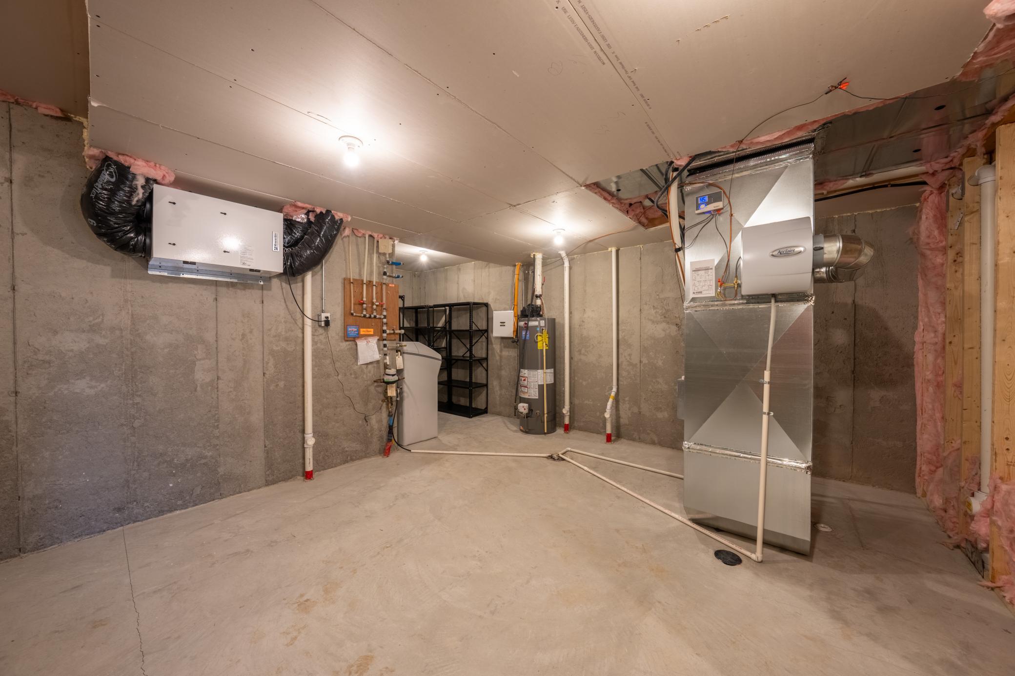 Clean, dry utility / storage room in basement. Owned water softener, Aprilaire humidifier, sump pump with battery backup and radon reduction system already installed!