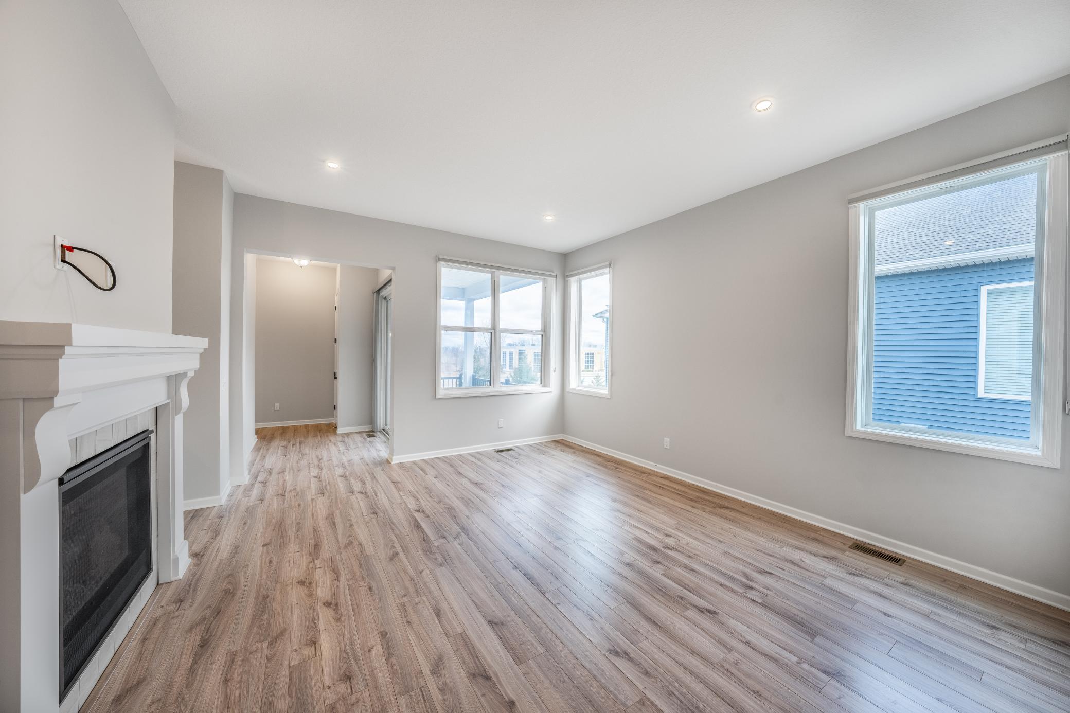 Living room with 10 ft. tall ceilings, 8 ft. doorways, recessed lighting, and a gas fireplace!