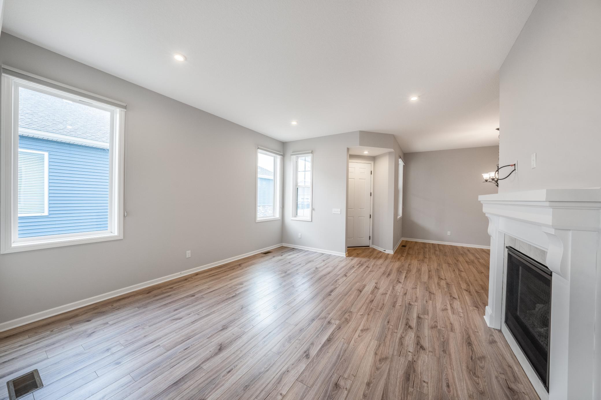 Large living room with 10 ft. ceilings, 8 ft. doorways, and a gas fireplace.