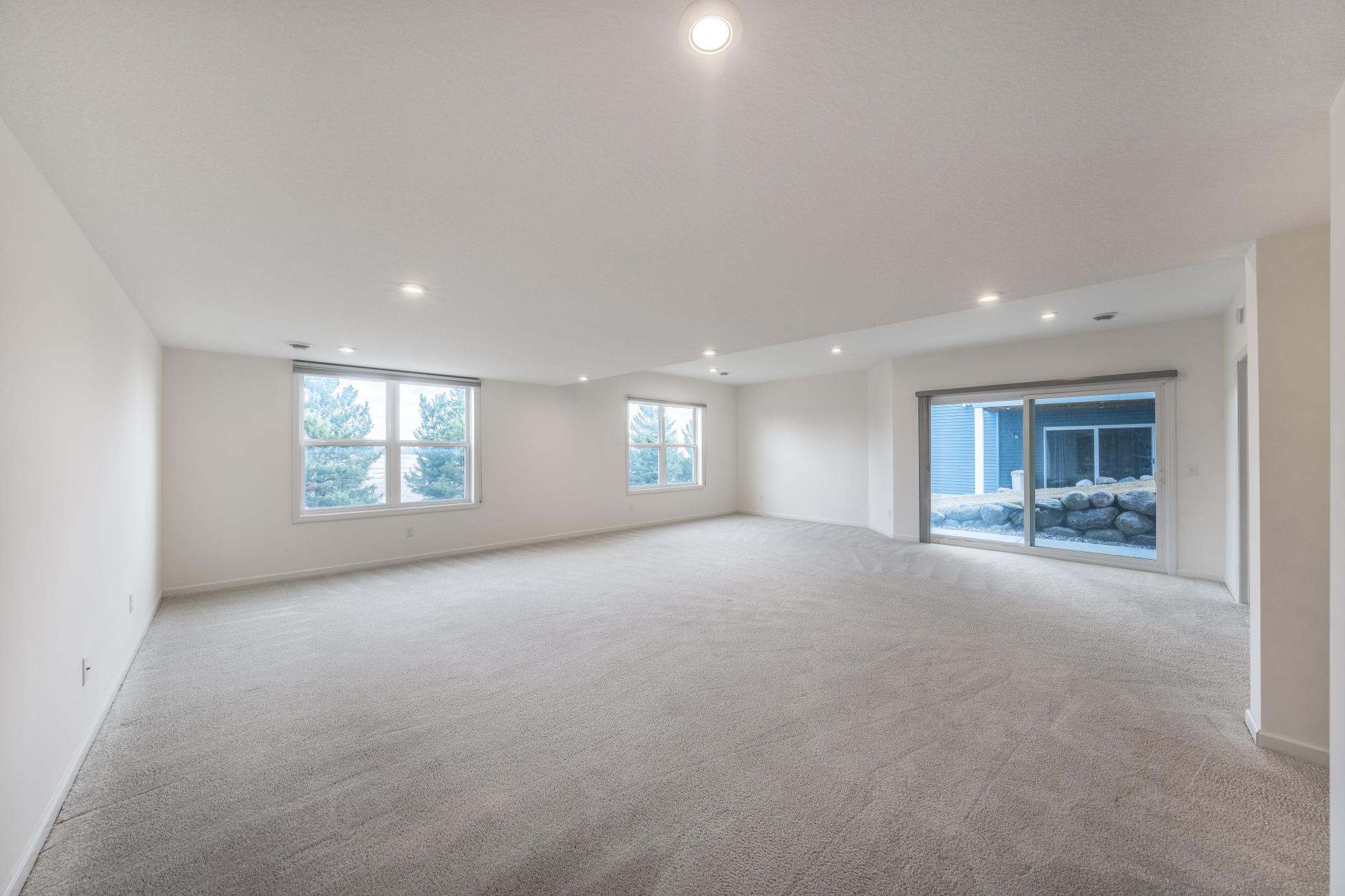 HUGE lower level family / game / bonus room walking out to patio!