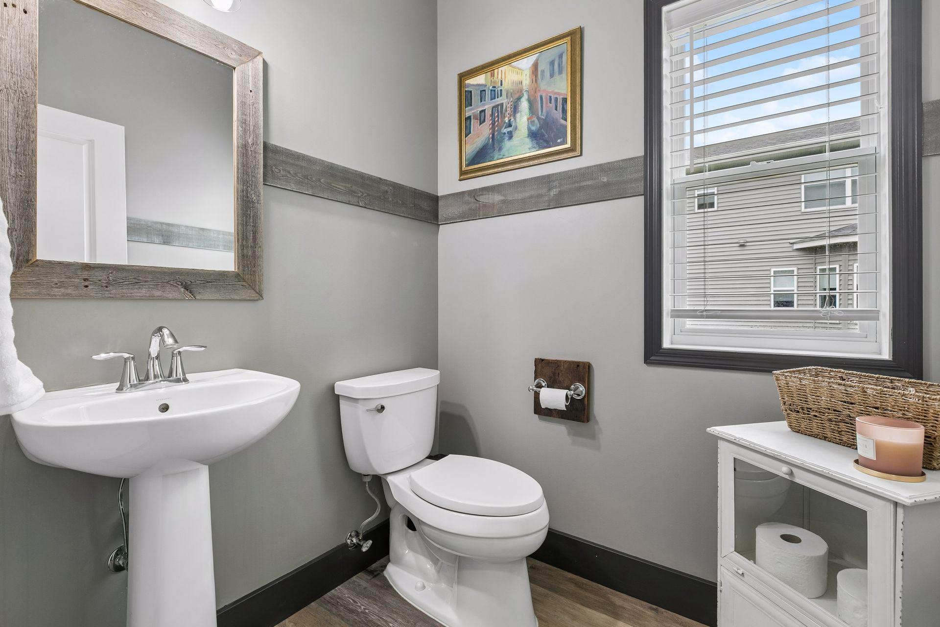 Main floor powder room finished with modern stylings. All trim and baseboards were updated in the house 2025.