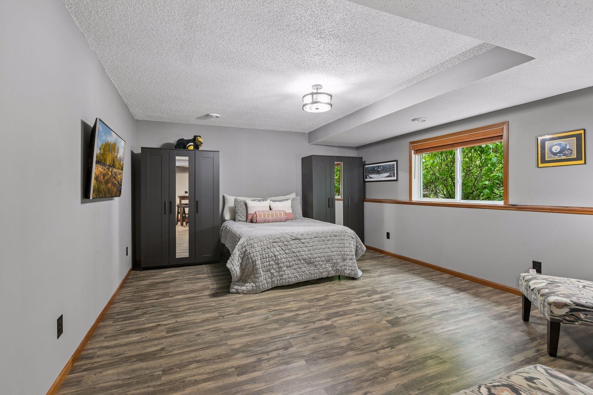 5th bedroom in lower level, spacious with daylight windows and with privacy for guests.
