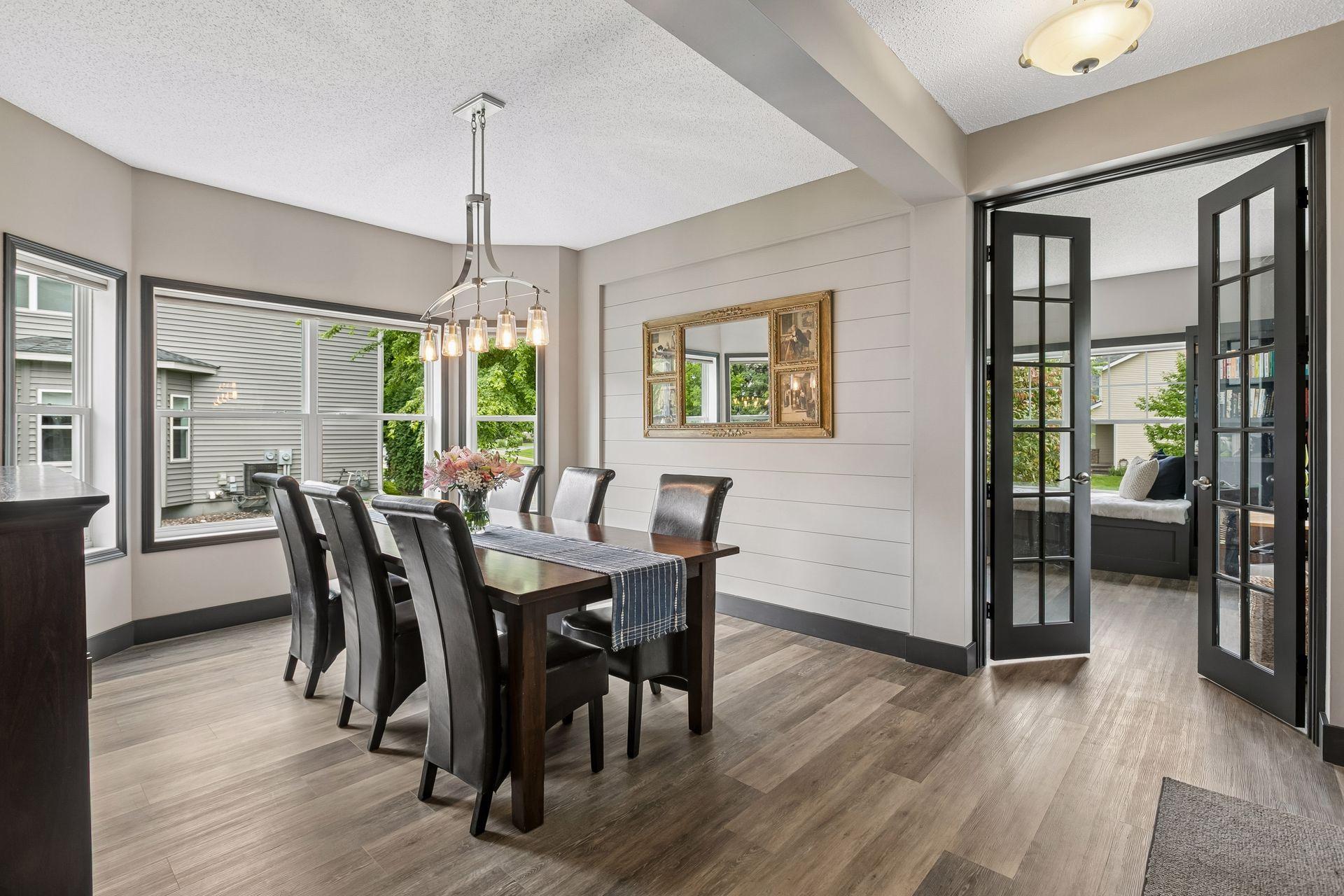 Newer LVP flooring on main and upper levels, dining area with bay window, shiplap accent wall and French doors to ideal main floor office. Perfect to work from home with enough space for quiet focus.