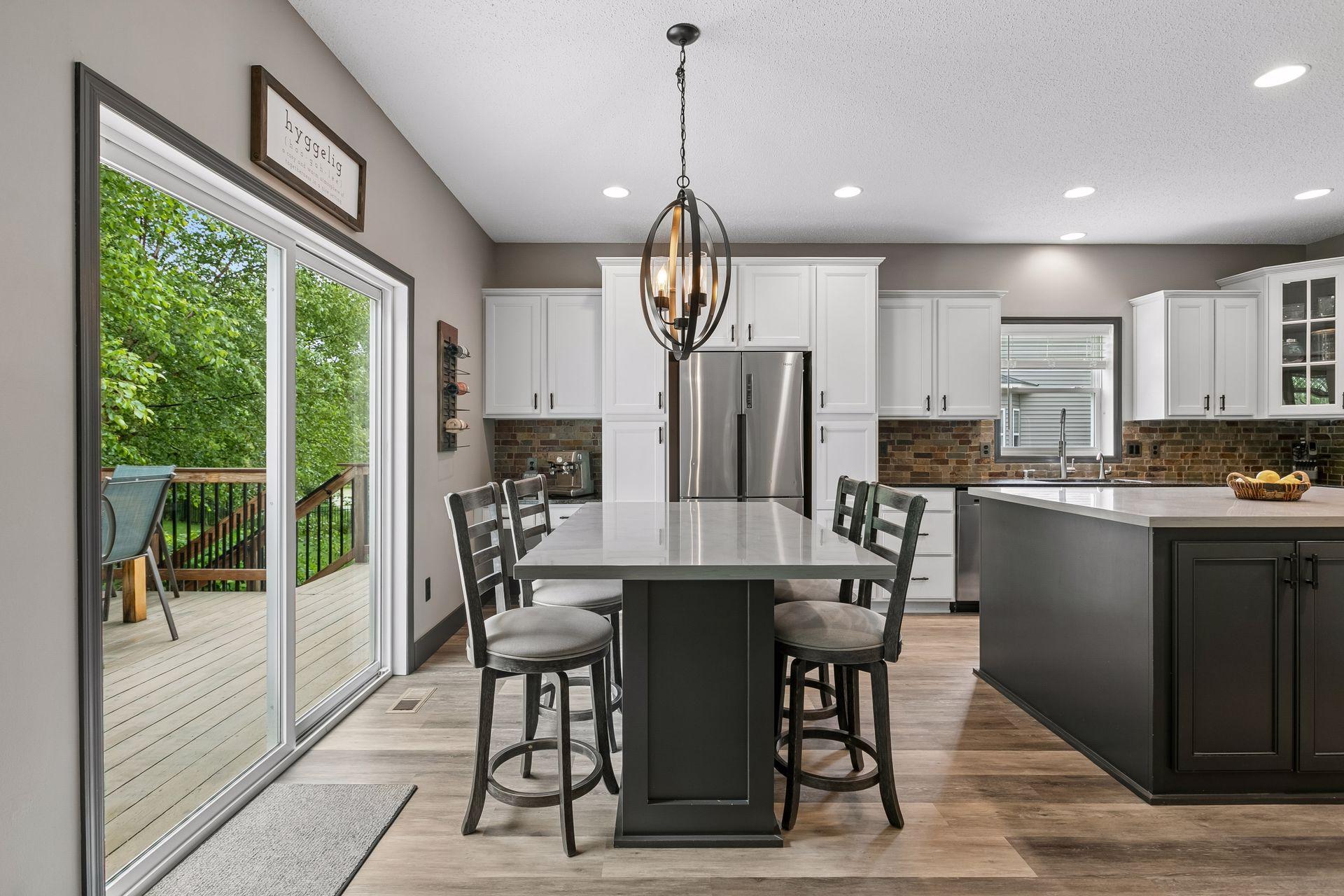 Eat-in kitchen area to deck, with steps visible to backyard. This table is built into the house.