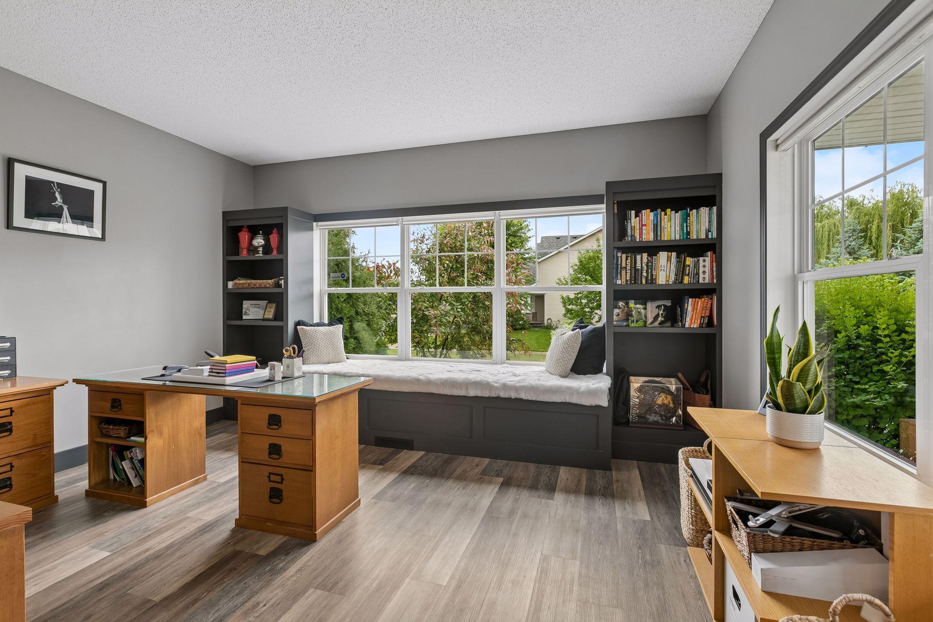 Large main floor office with built-in window seat, shelving and glass French doors for privacy. Could be used as a playroom, music or exercise room, or guest bedroom.
