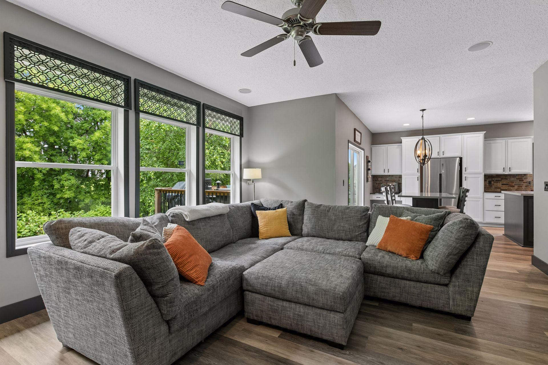 Main floor family room to kitchen/eat in dining area. Patio doors and deck visible to the left.