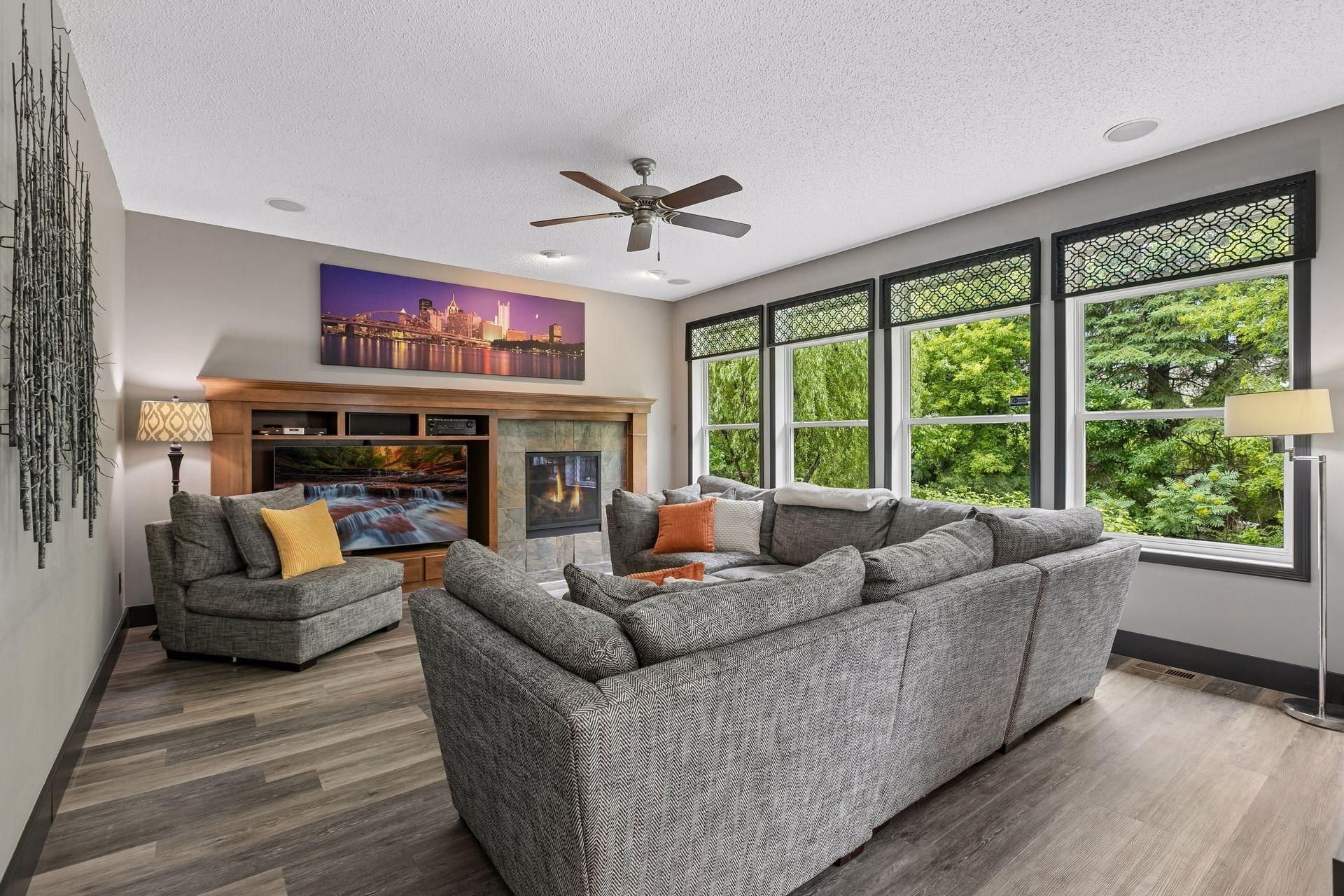 Main floor family room overlooks treetops with gas fireplace, custom built-ins, high ceilings and recessed lighting. Bank of oversized windows lets in ample natural light, making this space airy for everyday use or entertaining.