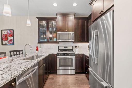 Gourmet Kitchen w/ granite counters, SS apps (inc gas range), under-mount sink, gorgeous wood cabinetry, subway tile backsplash & pantry