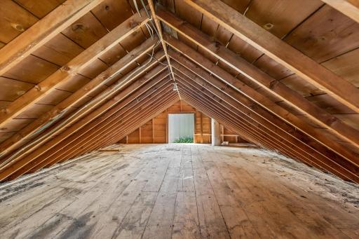 Loft in garage with stairs inside and carriage doors outside. Owner said this was the neighborhood hangout for the kids. There is electric & lighting. There used to be a heater in the garage and the chimney is still in tact. Ceiling is approx 6' 4"