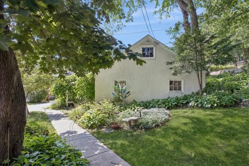 Charming rear yard and oversized garage with loft and windows.