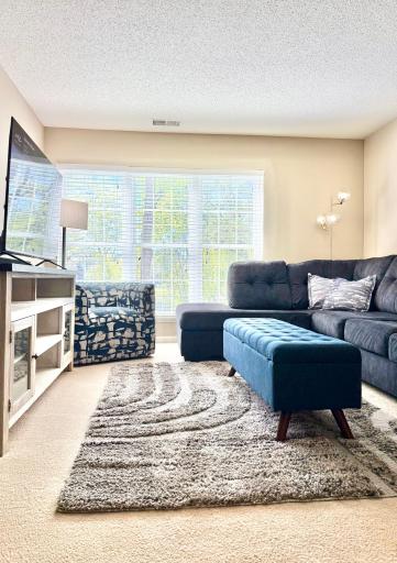 Living room space with beautiful green views.