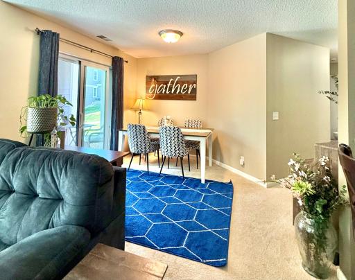Informal dining is located near the patio door, and the breakfast bar is at the right edge of this photo.