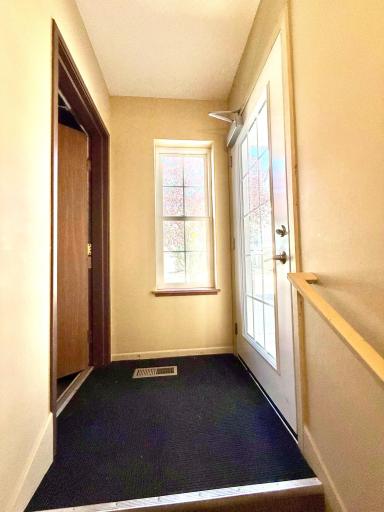 Entry landing with garage access; stairs lead down to the home.
