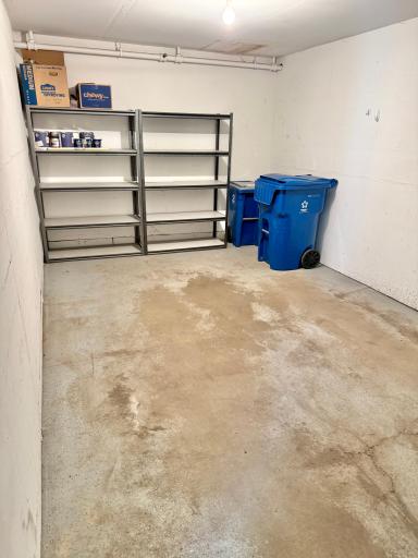 Your attached, finished single garage with storage shelves & ample space.