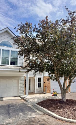 Welcome Home! Unit entry is the glass-paned door just left of the ground-level window. Attached garage is the first next to the brick.