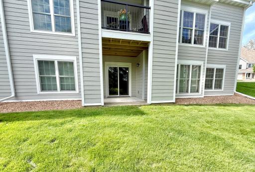 Unit is the bottom-floor walk-out. Windows are (from left) bedroom #2, living room, primary bedroom.