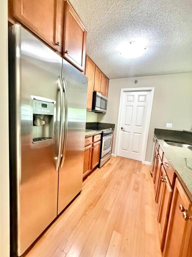 Mounted microwave and refrigerator with ice-maker and filtered water dispenser.