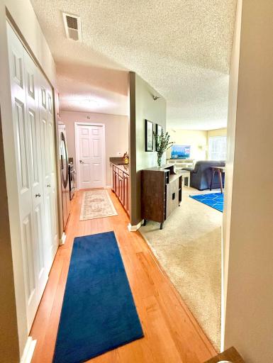 View from the entry door looking left into the home. Toward the right is the full bathroom and bedroom #2.
