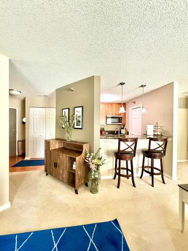 View from the informal dining area, in front of your patio doors. To the right is the entry to the primary bedroom suite.