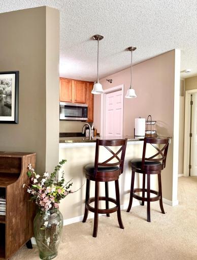 Breakfast bar and primary bedroom entry on the right.