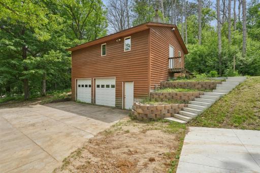 The detached garage is 32 x 26 and has two 8' doors. The upper level is a finished shop area.