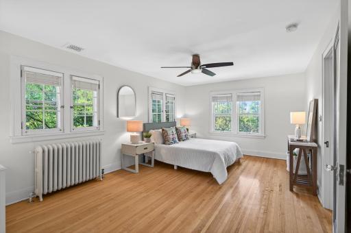 Spacious primary retreat filled with natural light and beautiful hardwood floors.