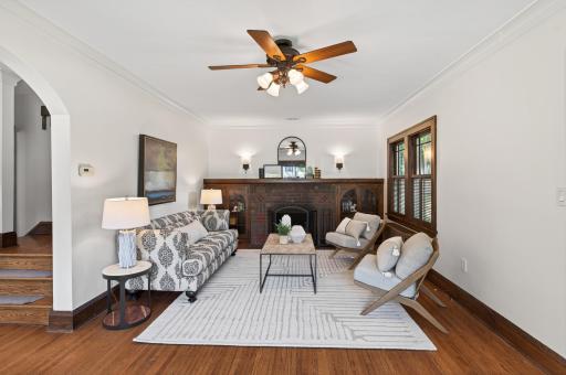 A handsome fireplace anchors this warm and inviting gathering space.