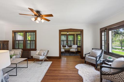 Beautiful sightlines connect the living room to the adjoining sunroom beyond.