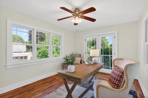 French doors open to a charming Juliet balcony overlooking the backyard canopy.