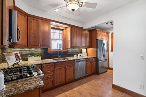 Beautifully updated kitchen featuring custom cabinetry, granite countertops, and stainless steel appliances.
