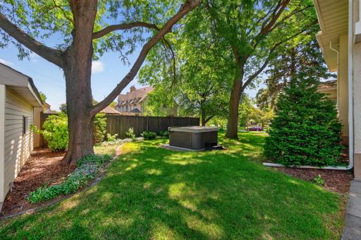 Hot tub tucked beneath the trees offers year-round enjoyment.