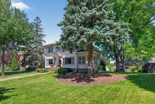 Beautifully landscaped grounds and mature trees create an impressive first impression.