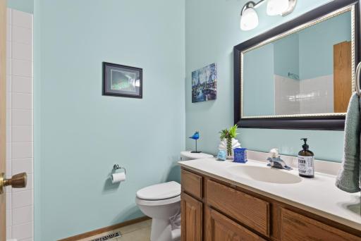 Main level full bath with vaulted ceiling, tile flooring.