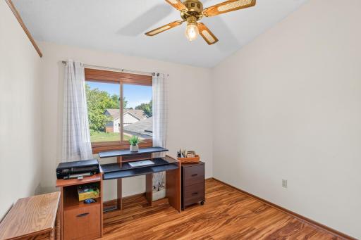Upper level 3rd bedroom, laminate flooring, ceiling fan, vaulted ledge.