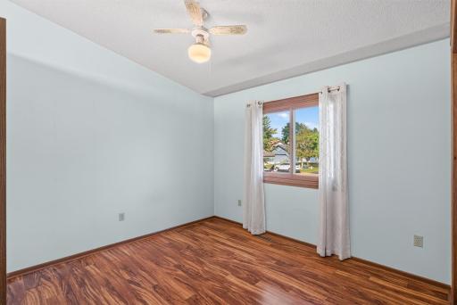 Upper level 2nd bedroom, ceiling fan, vaulted ceiling.