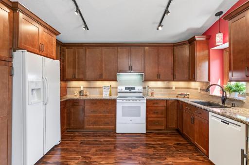 Another kitchen view, cherry cabinets, kitchen window with ledge. Windows and vaulted ceiling offer alot of natural light!