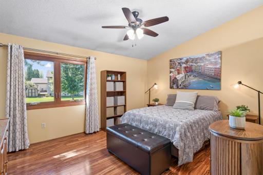 Large primary Bedroom suite, vaulted ceiling, ceiling fan, laminate flooring.