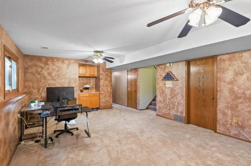 Back bar with storage, under stair storage, and large laundry/utility room.