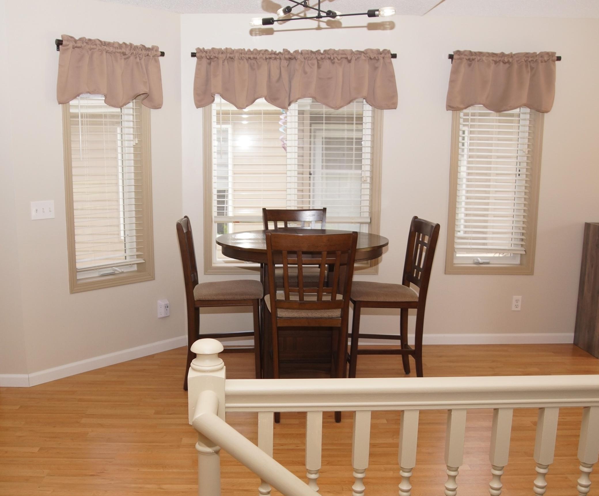 Dining area between kitchen and living room with newer laminate flooring!